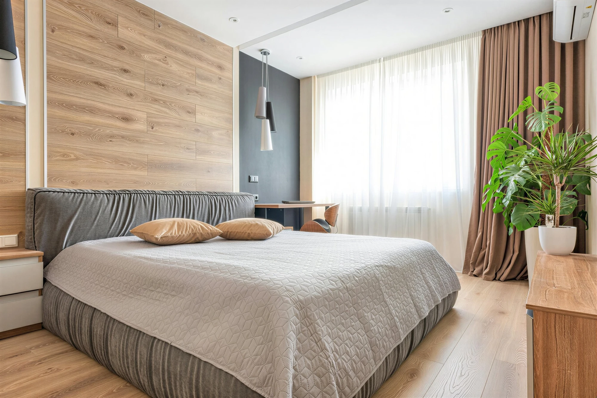 High-resolution Modern living room with brick wall, teal sofas, wood stove and red rug